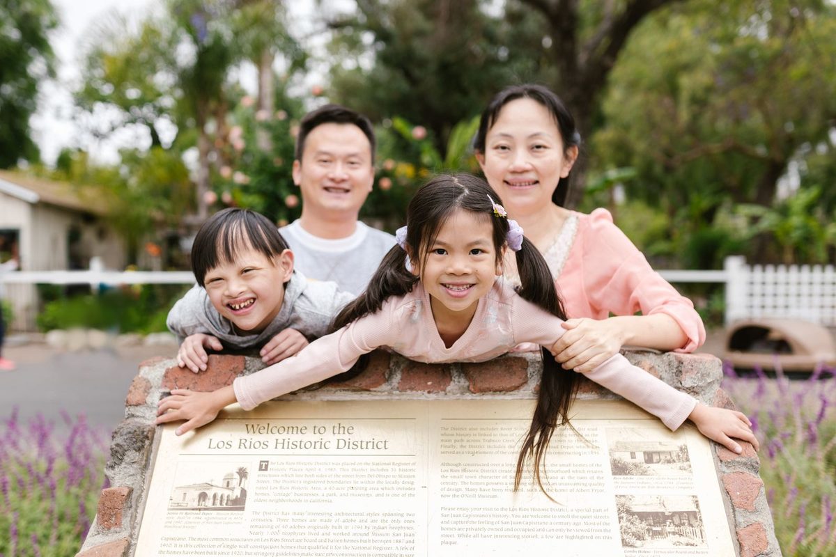 A multigenerational family smiling together outdoors
